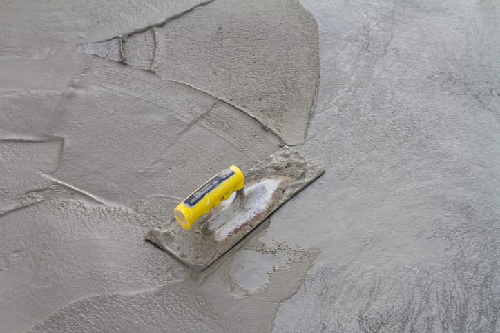 Trowel on fresh concrete at construction site